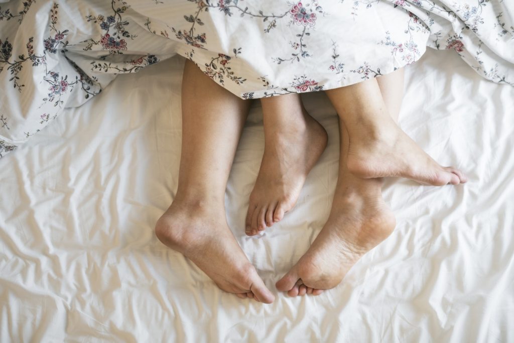 Symbolbild Sexualität: Füße von zwei Personen unter einer Bettdecke, Credit: rawpixel, Unsplash